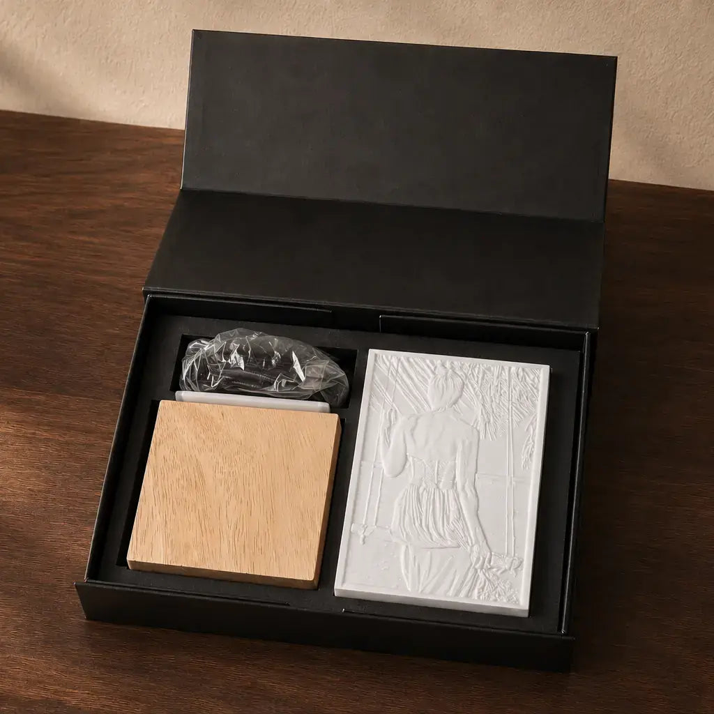 Geöffnete schwarze ArtLight Geschenkbox mit Holzfuß, Foto-Relief, Kabel und Leuchtmittel